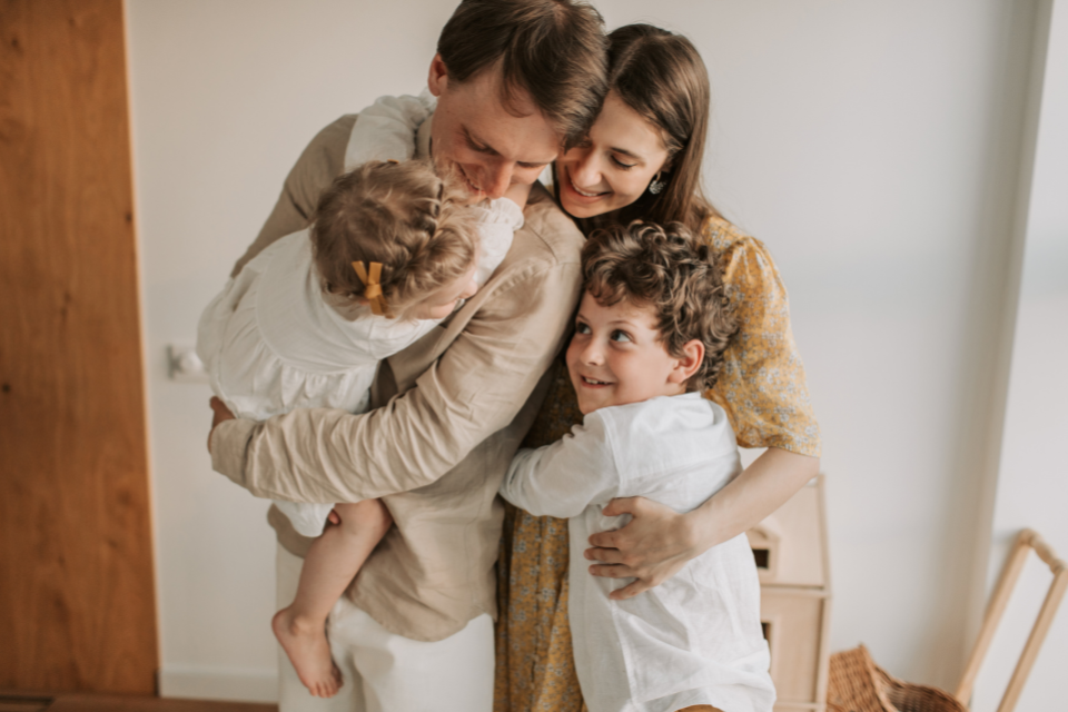 Family hugging at home, reflecting how to Secure Your Retirement while caring for loved ones